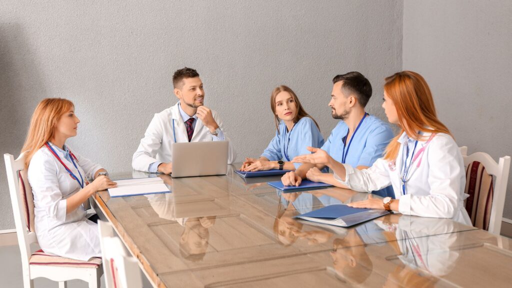 Mental health professionals discussing dual diagnosis treatment in outpatient settings during a clinical training session